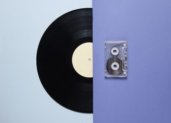 Audio cassette, vinyl record on blue gray background. Retro style. Top view