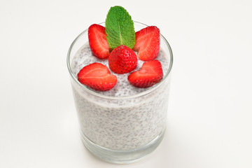 Chia pudding with strawberry and mint on a white background. Space for text or design.
