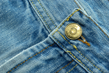 Close up of Blue jeans,Detail of vintage jeans texture with pocket studs and stitch with selective focus.