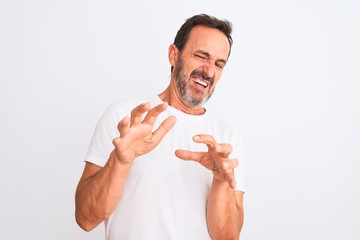 Middle age handsome man wearing casual t-shirt standing over isolated white background disgusted...
