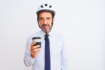 Middle age businessman wearing bike helmet drinking coffee over isolated white background with a confident expression on smart face thinking serious