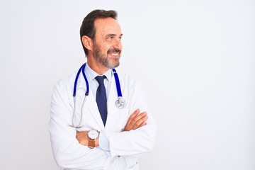 Middle age doctor man wearing coat and stethoscope standing over isolated white background smiling looking to the side and staring away thinking.