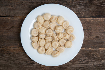 boiled dumplings in a plate on a wooden table