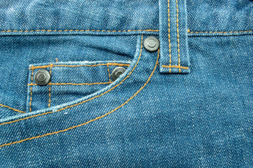 Close up of Blue jeans,Detail of vintage jeans texture with pocket studs and stitch with selective focus.