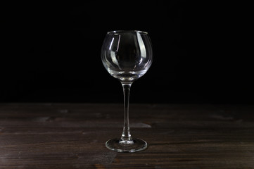 Photo of an empty wine glass. Nice color on a black background.