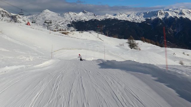 Snowboarding in the alps, making turns, follow shot