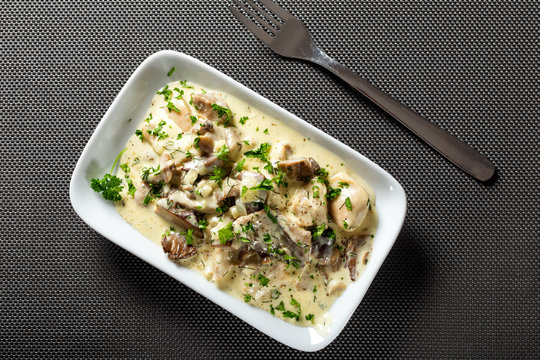 Chicken meat with mushrooms and cream with herbs