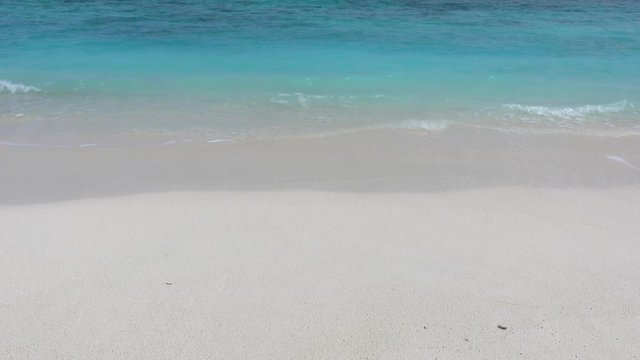 Soft waves on white sand beach. Turquoise water. 4K stock video