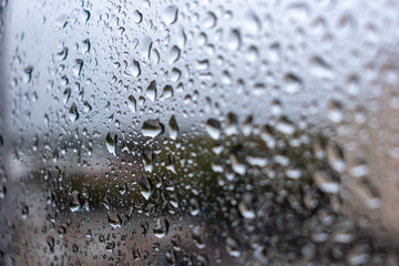 Fototapeta na wymiar Water drop background on window glass in rainy day