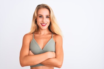Young beautiful woman wearing casual green t-shirt standing over isolated white background happy face smiling with crossed arms looking at the camera. Positive person.