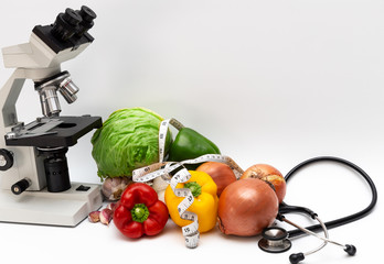 some mixed vegetables, with a microscope and stethoscope, as a concept of alternative medicine,...