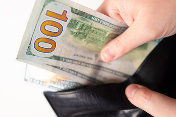 Money. Dollars. A man takes out money from a wallet. Dollar bills. Capital. Family budget. Cost control. Saving money. Dollars received from the sale. Concept - management of the budget of the family
