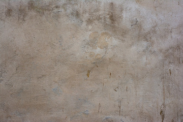 Concrete surface painted in light pastel colors with a rough texture.