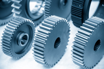 The close-up scene of various type of  the pinion gear parts shaft  in the light blue scene. The mechanical parts manufacturing process concept for automotive industrial .