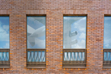 The plane flies close to the residential quarter and is reflected in the windows of the house. Airplanes from the nearest airport interfere with local residents.