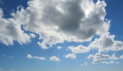 Blue sky with beautiful fluffy clouds,  natural background 