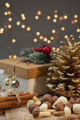 Christmas pastries, mushrooms for the new year with cinnamon. Gift boxes with winter details, cones and balls.