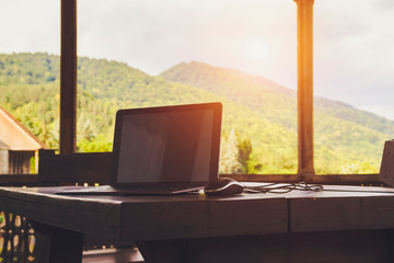 Notebook on a wooden table on a background of mountains