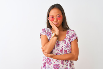 Young chinese woman wearing floral t-shirt and pink glasses over isolated white background thinking looking tired and bored with depression problems with crossed arms.