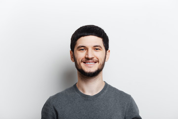 Portrait of young smiling man on white background.