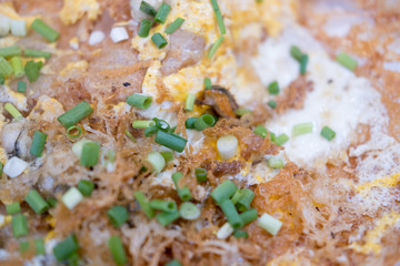 Fried oysters with crispy omelette topped with chopped spring onion