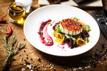 Grilled goat cheese salad served on a plate in restaurant