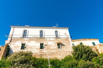 Fototapeta na wymiar Old white building and city wall in Termoli, Italy