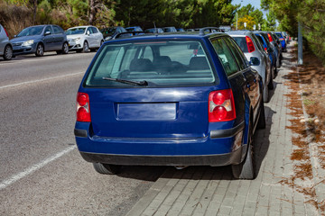 Cars or automobiles parked over the curb into sidewalk, leaving no space for pedestrians in the...