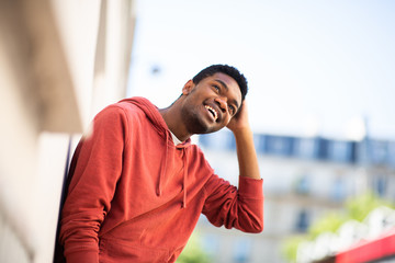 young african american man smiling with hand behind head