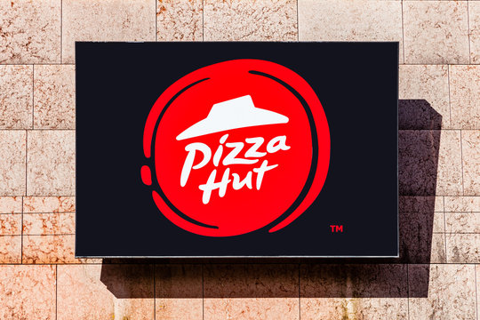 Almada, Portugal - October 24, 2019: Signboard advertising Pizza Hut restaurant in a shopping center or shopping mall exterior wall