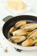 Braised chicory on the belgian way in a baking pan 