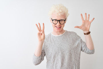 Young albino blond man wearing striped t-shirt and glasses over isolated white background showing...
