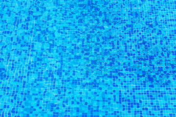 blue clear water of swimming pool with mosaic bottom