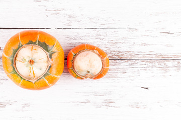 Ugly pumpkins with mutation on white wooden table background with copy space. Concept of zero waste...
