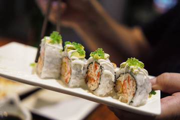 Sushi inside out rolls with avocado and fried shrimps