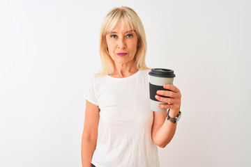 Middle age woman drinking glass of take away coffee standing over isolated white background with a...