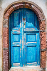 A weathered Blue Greek Doorway on the Greek Island of Santorini