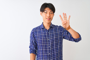 Young chinese man wearing casual blue shirt standing over isolated white background showing and pointing up with fingers number four while smiling confident and happy.