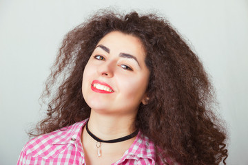 Portrait of a smiling girl with magnificent curly hair