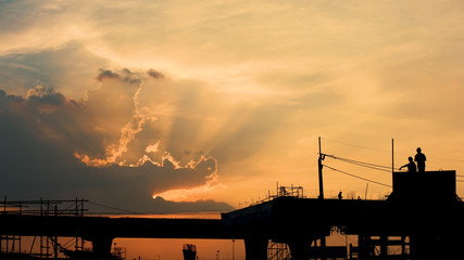 Silhouette Sunlight shining through the clouds over construction site