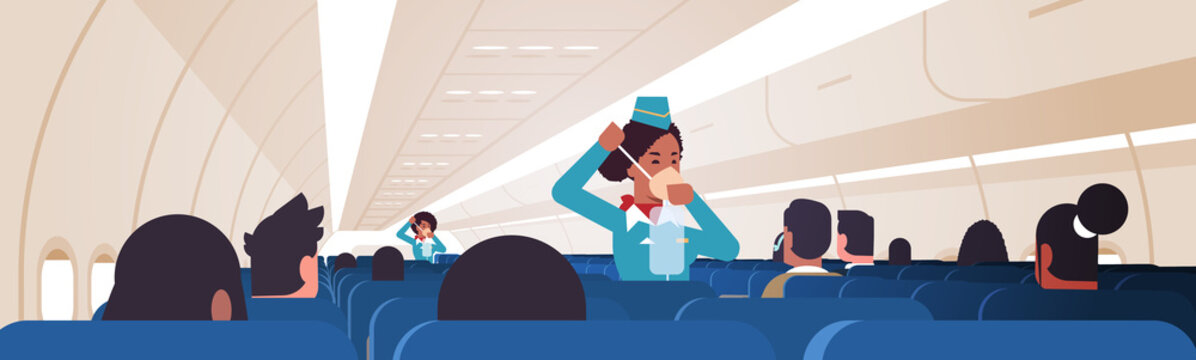 stewardess explaining for passengers how to use oxygen mask in emergency situation african american flight attendants safety demonstration concept modern airplane board interior horizontal vector