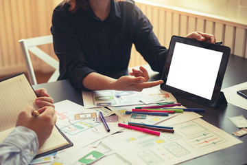 Team of design app on mobile phone and tablet, offering idea to develop application.
