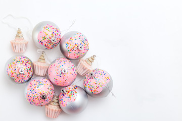 Christmas balls  and sparkles pastels colors on white background. Copy space