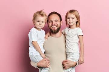 cheerful smiling daddy holding his kids in arms, parenthood, free time, spare time, close up...