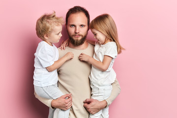 bearded handsome unhappy sad man is tired of looking after the children, tiredness, close up portrait, studio shot