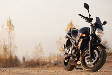 Fototapeta na wymiar One black motorcycle in the desert.