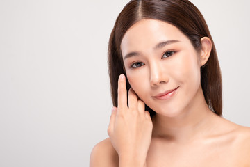 Beautiful Asian young woman touching soft cheek smile with clean and fresh skin Happiness and cheerful with positive emotional,isolated on white background,Beauty and Cosmetics Concept
