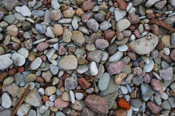 smooth colorful pebbles on the beach background