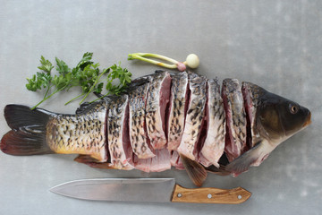 carp fish meat with greens on the table