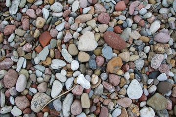 smooth colorful pebbles on the beach background